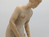 marble statue of a boy with a bowl on a pedestal