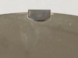 a silver purse with a metal handle on a white surface