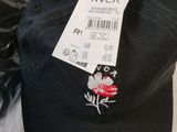 a black hat with a red rose on it
