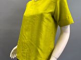 an image of a mannequin wearing a yellow shirt and black pants