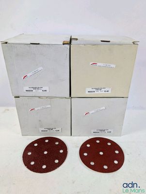 three discs of sand are sitting on top of a cardboard box