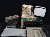 a lot of old electronics on a black table