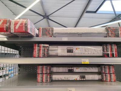 many boxes of soda sitting on the shelves in the store