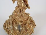 a gold figurine with a cheren on it