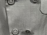 black and white photograph of a coat with buttons on a mannequin mannequin mannequin mannequin mannequin mannequin mannequin