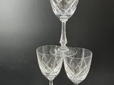 several wine glasses are stacked on top of each other on a table