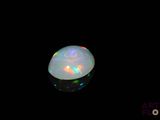 a close up of a white oplite in a black background