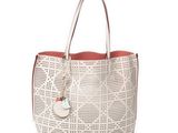 a white and red handbag with a heart shaped tag on it