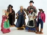five figurines of people dressed in traditional clothing