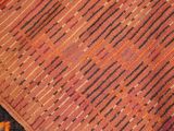 an image of a close up of a red and black area rug