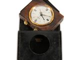 a clock that is sitting on top of a black case