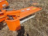 a small orange machine that is sitting in the grass