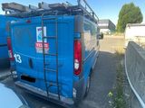 a blue van that is parked in a parking lot