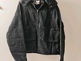 an image of a black jacket hanging on a hanger