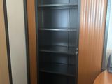 a black bookcase in the corner of a room