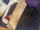 several pairs of gloves are laid out on a blue mat