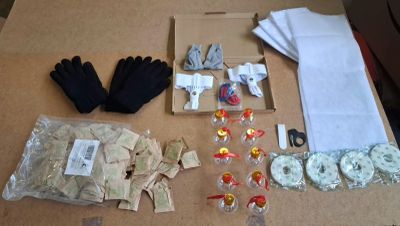 a table with many items on it including gloves, gloves, gloves, and other items