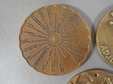 three different coins are shown on a table with a white background