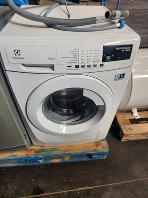 a washing machine sitting on a pallet in a warehouse