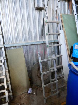 a blue barrel sitting in a room with a ladder next to it