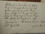 an old piece of paper with writing on it sitting on top of a table