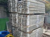 a pile of wood stacked on top of each other in a yard