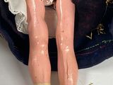 a doll that is sitting in a bag on a table