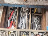 a drawer full of tools that are sitting on a table