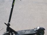 an electric scooter sitting on the ground in a parking lot
