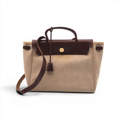 a brown and tan bag with a brown handle