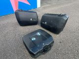 three pieces of luggage sitting on the ground next to each other