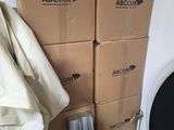 a stack of boxes and a chair in the corner of a room