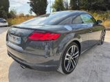 the rear end of a gray audi car parked in a parking lot