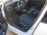 the interior of a car with the door open and the driver ' s seat down