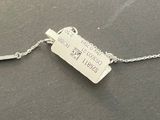 a tag that is attached to a chain on a table