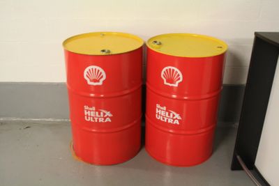 two red barrels sitting next to each other on the floor