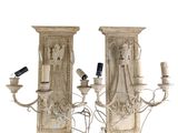 pair of carved wood sconces with candles and a remote control