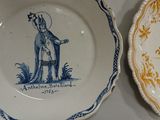 two plates that have blue and white designs on them