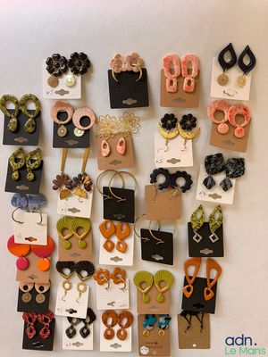 many different types of earrings on display on the wall