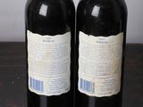 two bottles of wine that are sitting on a table