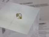 a yellow diamond sitting on top of a piece of paper