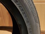 a close up of a tire on a cardboard box with a cardboard box in the background