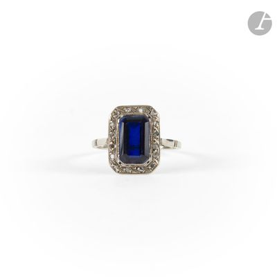 a blue sapphire and diamond ring on a white background