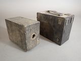 two old suitcases sitting next to each other on a table