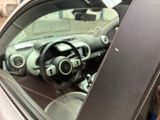 a car that is parked in a garage with its door open
