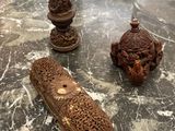 three pieces of carved wood sit on a table in a living room