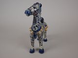 a blue and white horse figurine on a white surface