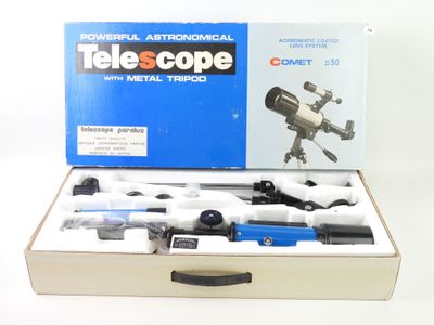a box with a telescope and other items in it
