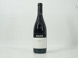 a bottle of wine sitting on top of a white table