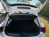 a car with the trunk open on the side of the road